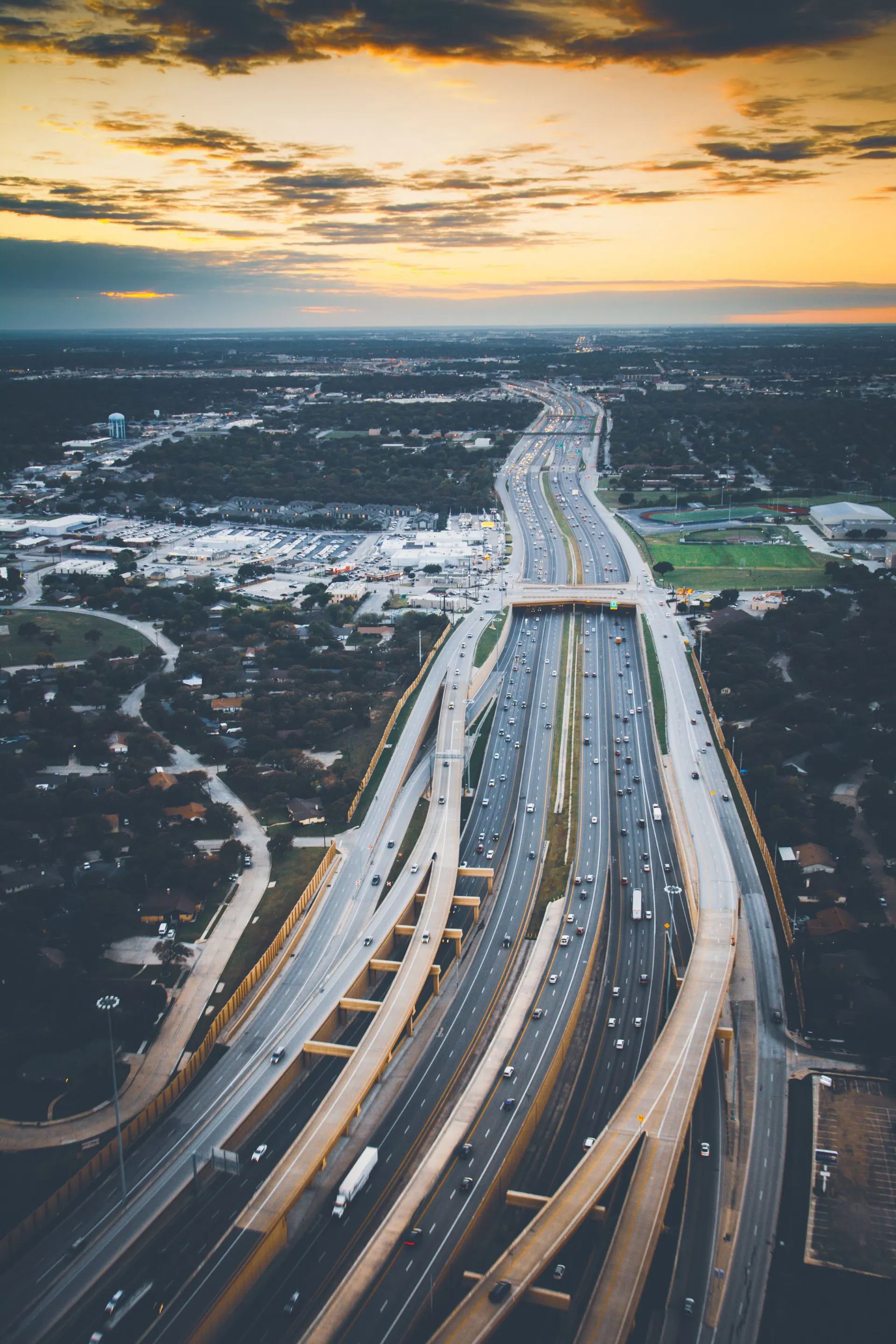 Aerial view of a wide expressway at sunset