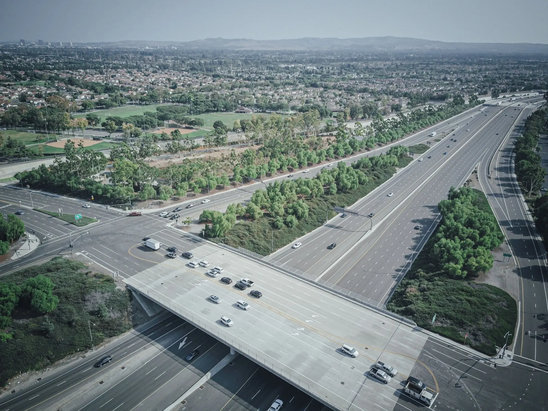 Aerial drone view of vehicles on a wide highway interchange